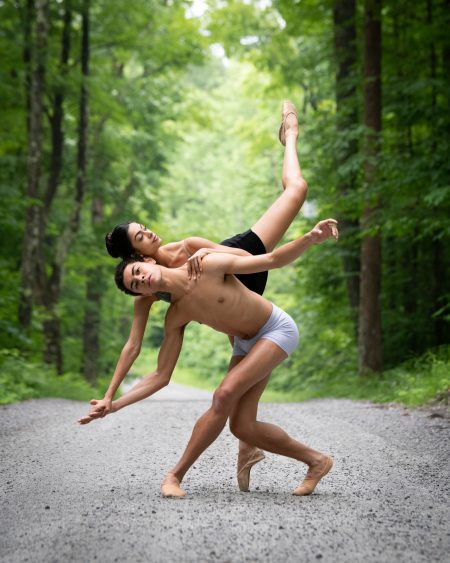 Two ballet dancers on a path in the woods