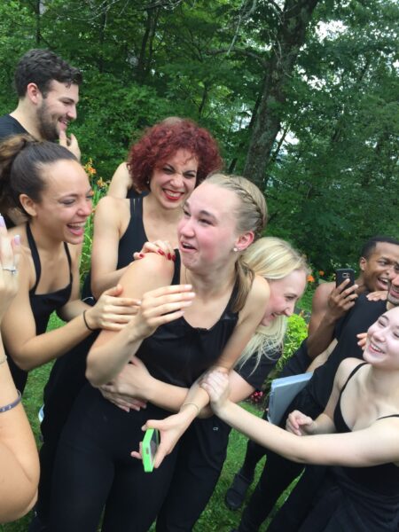 Kathleen Laituri cries tears of joy after receiving the call that she was selected to be a Radio City Rockette. She stands outside at Jacob's Pillow and is surrounded by other dancers in the 2017 Musical Theatre Dance program.