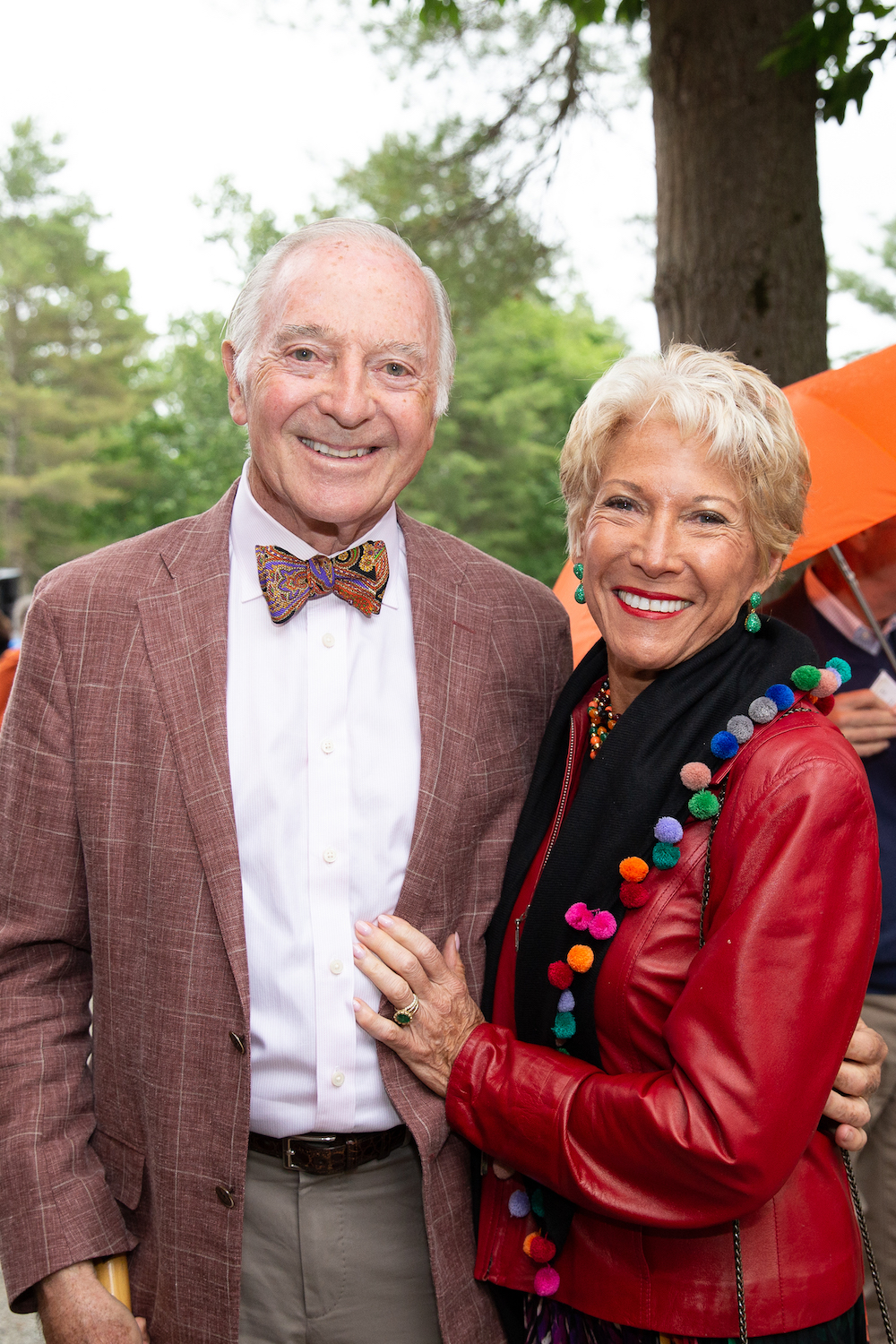 An elderly couple smile for the camera.