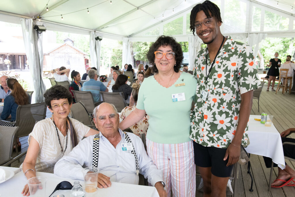 "J.R." Glover and Sterling Harris pose with two School Sponsors at the School Sponsor Luncheon.