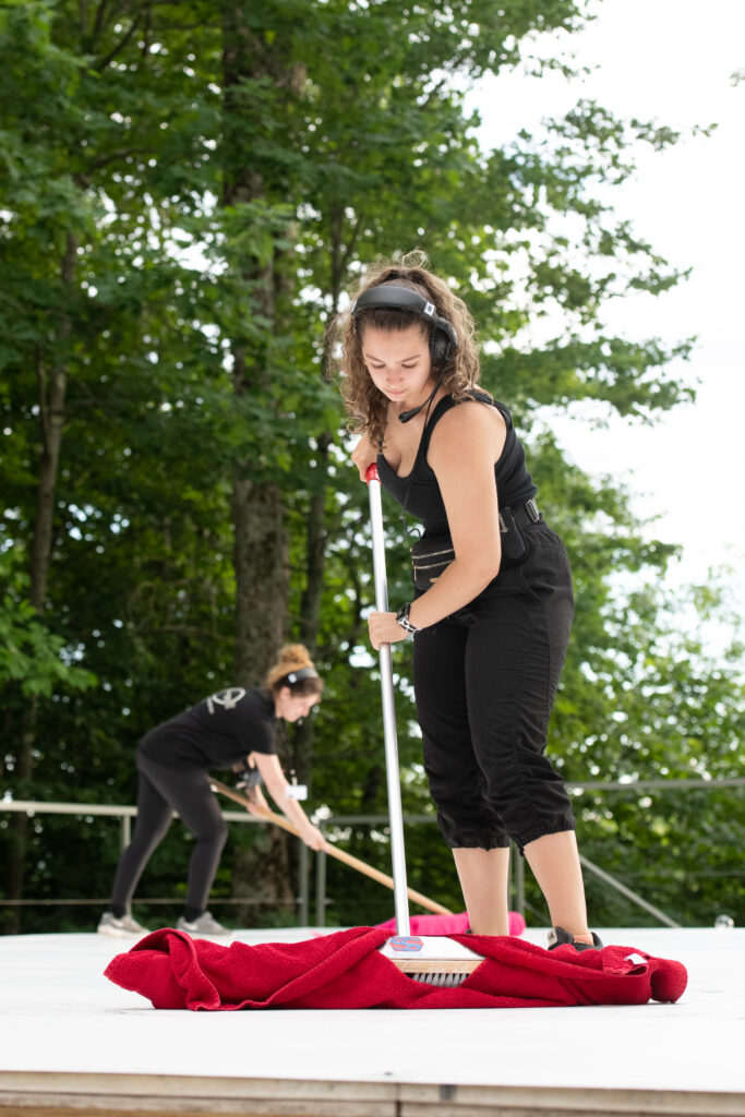 Chayanne McNeil mops the outdoor Henry J. Leir Stage.