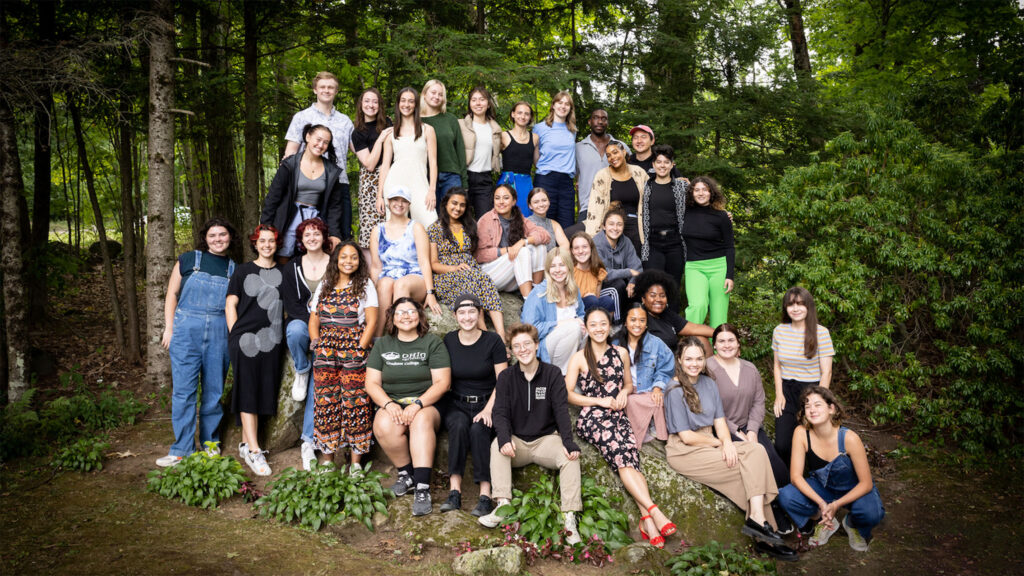 The 2022 Intern Cohort smile and sit on the Pillow Rock