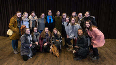 A group of people pose for a photo with Kyle Abraham.