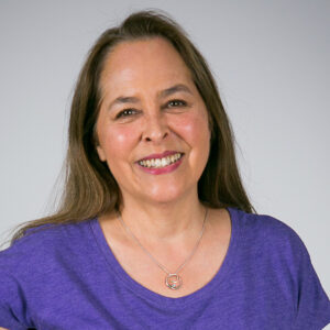 Headshot of Ann Biddle smiling and wearing a purple shirt
