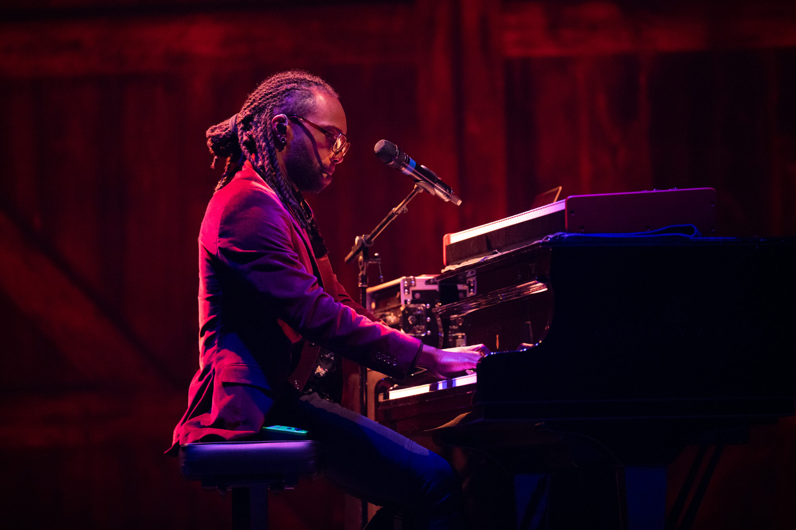 Photo of a man singing and playing the piano in the Ted Shawn Theatre.