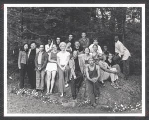 Black and White image of a cast of dancers outdoors around and on the Pillow Rock.